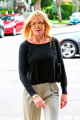 Melanie Griffith wearing gold mirrored retro sunglasses, has lunch with a a male companion in West Hollywood Featuring: Melanie Griffith Where: Los An...-stock-photo