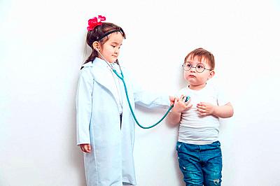 Child in a suit of the doctor with the patient-stock-photo